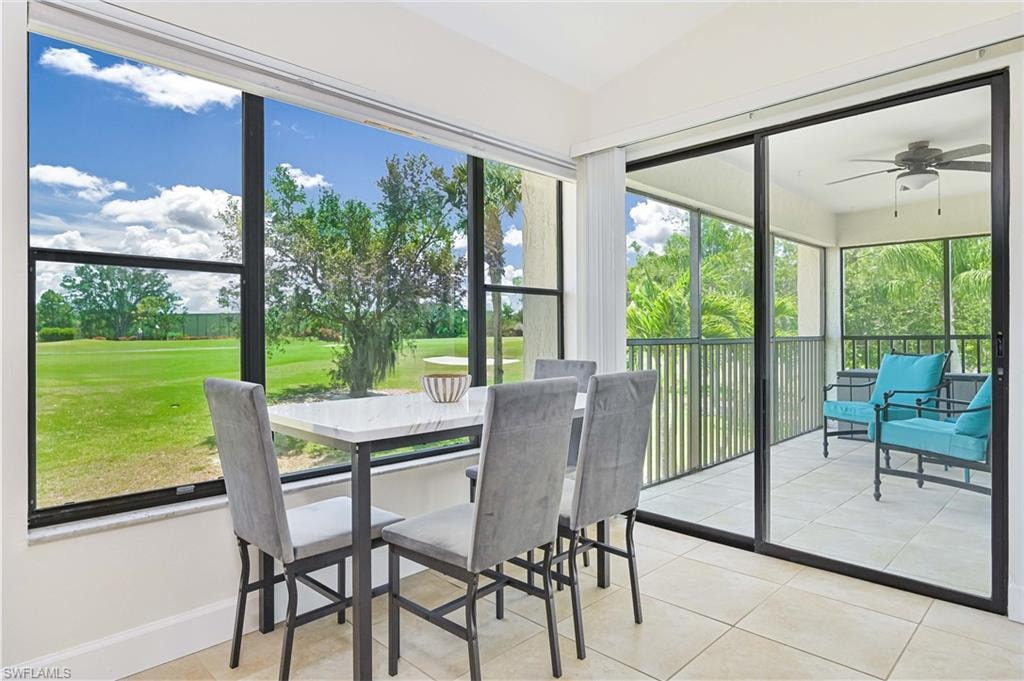 Sunroom / solarium featuring ceiling fan and golf course view
