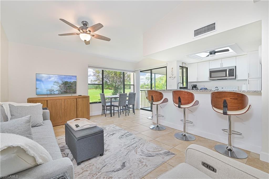 Living room featuring ceiling fan and light tile patterned flooring