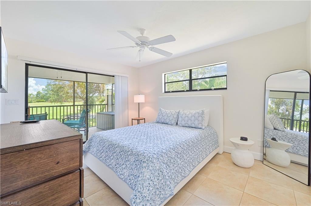 Bedroom with access to outside, a ceiling fan, and light tile patterned floors
