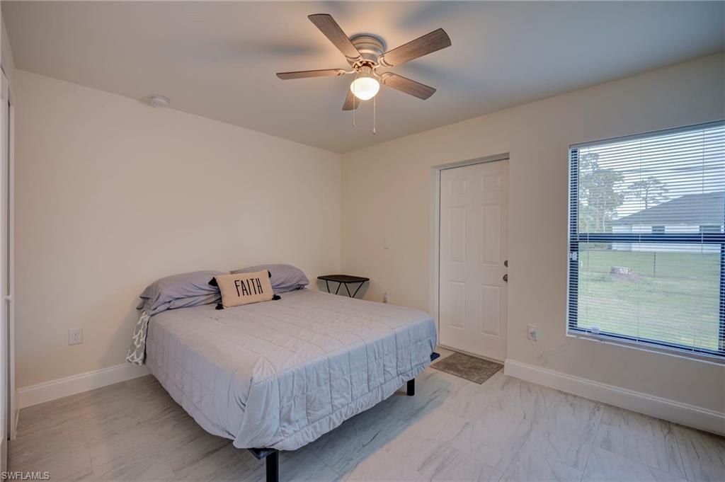 Bedroom with baseboards and a ceiling fan