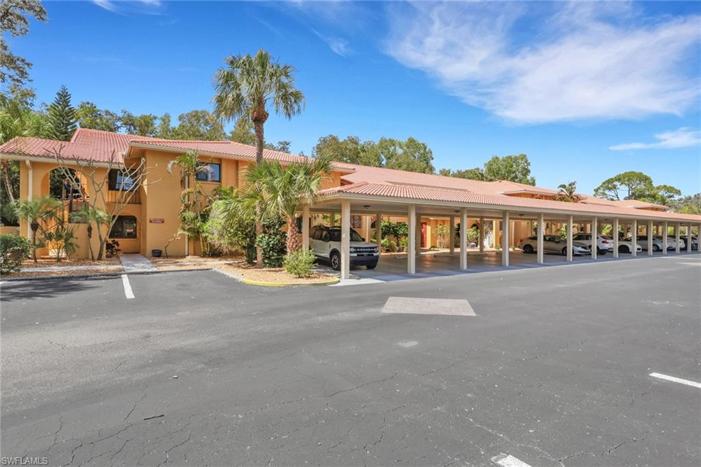 View of property featuring covered parking