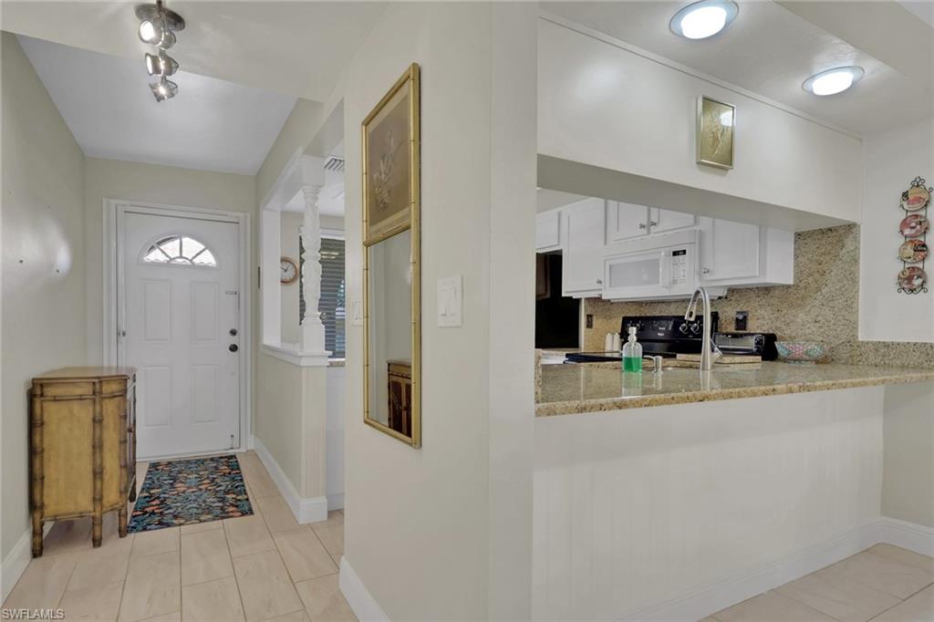 Entrance foyer with baseboards and light tile patterned flooring