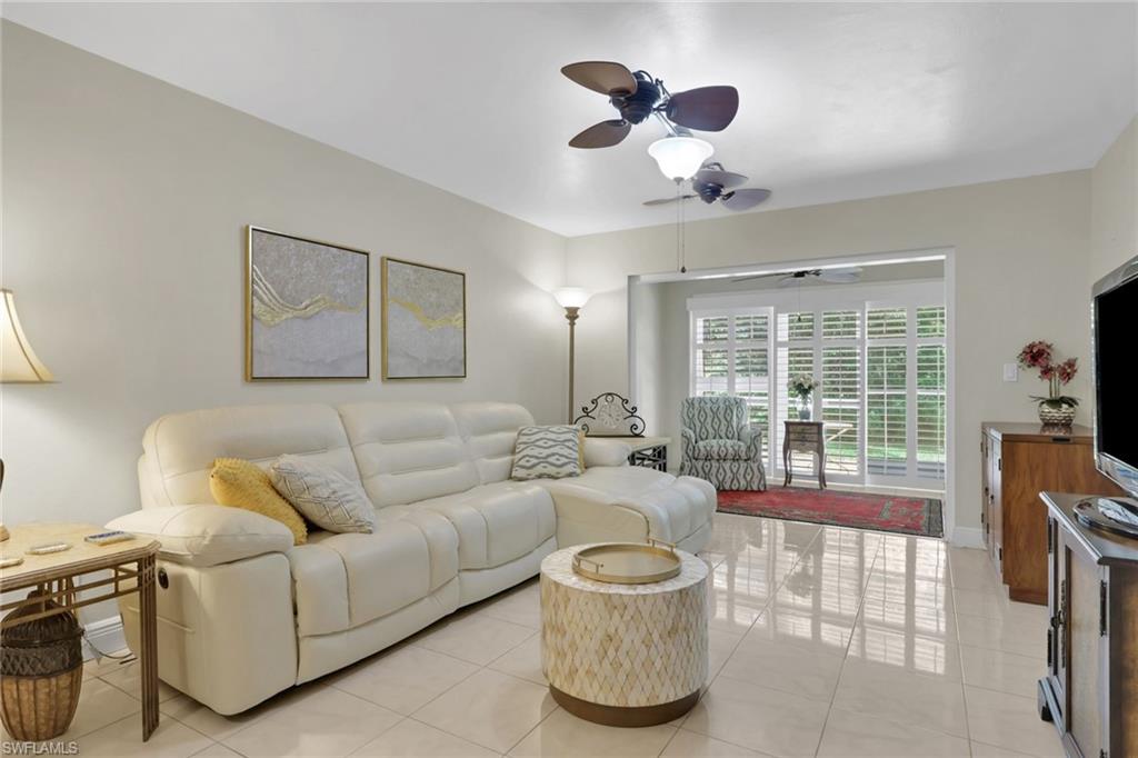 Living room featuring ceiling fan and light tile patterned floors