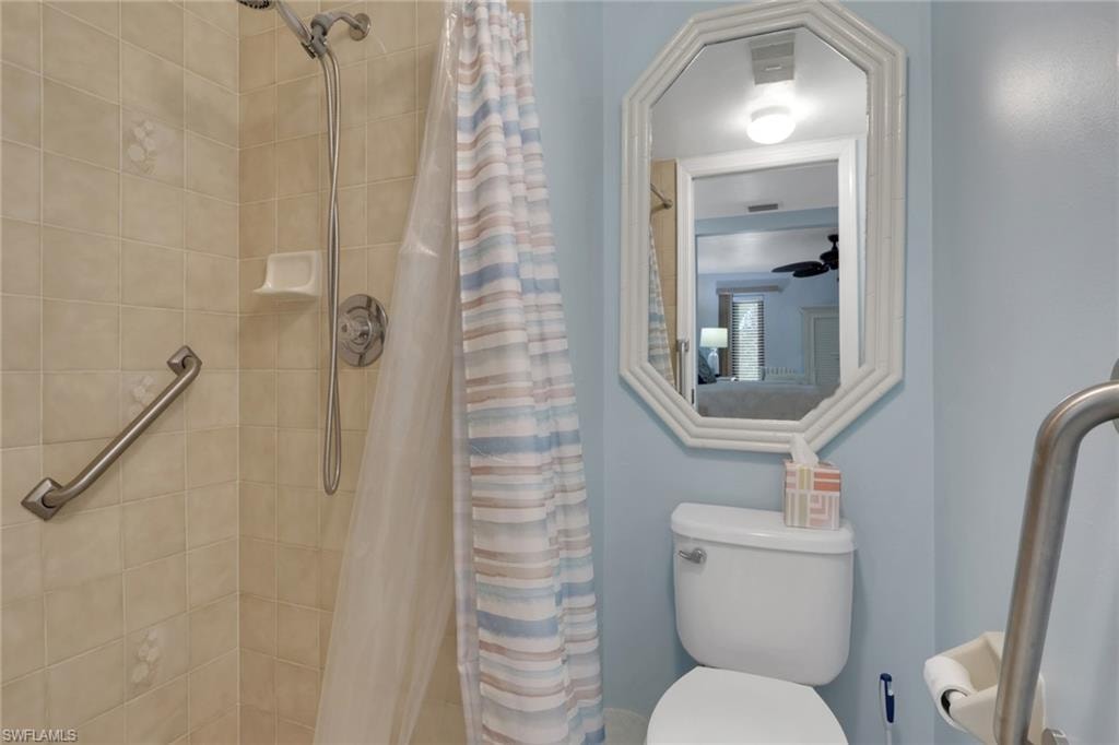 Bathroom with a stall shower and toilet