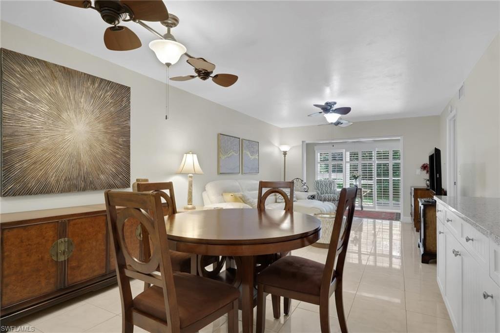 Dining room with a ceiling fan and light tile patterned floors
