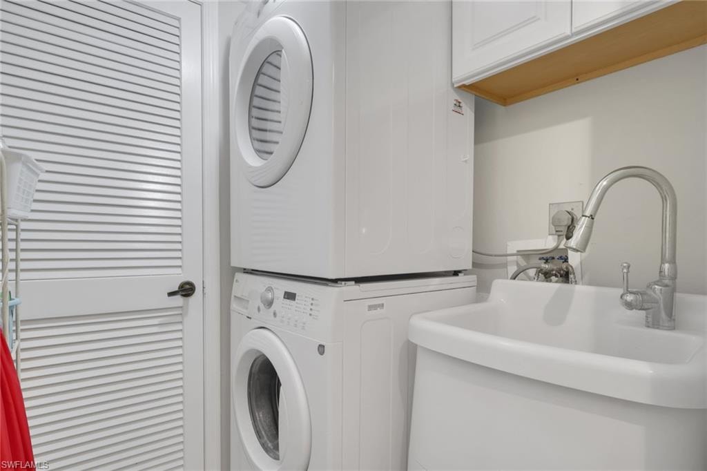 Laundry area featuring stacked washer and clothes dryer