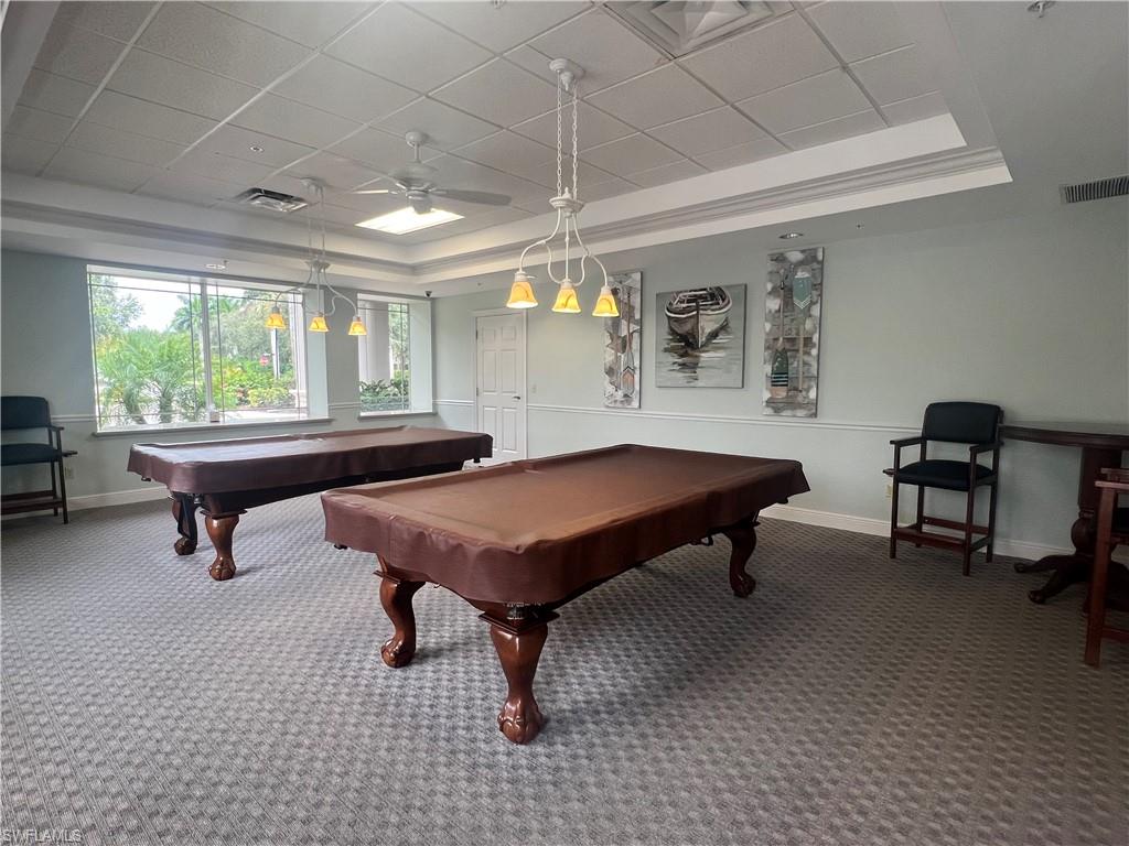Recreation room featuring crown molding, carpet floors, ceiling fan, a tray ceiling, and billiards