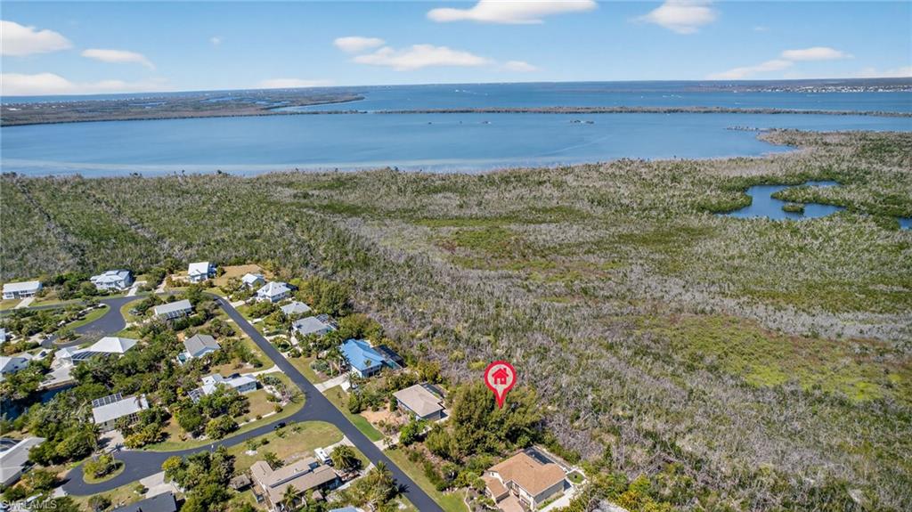Aerial perspective of suburban area featuring a nearby body of water