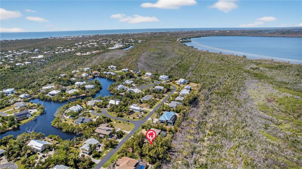 Aerial perspective of suburban area featuring a large body of water