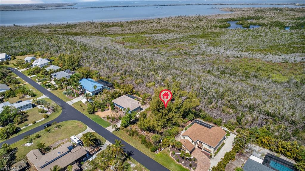 Aerial perspective of suburban area featuring a nearby body of water