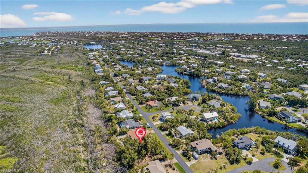 Aerial perspective of suburban area featuring a large body of water
