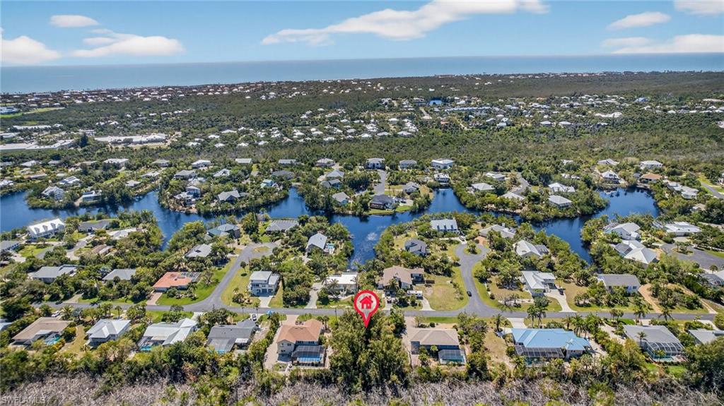 Aerial perspective of suburban area featuring a large body of water