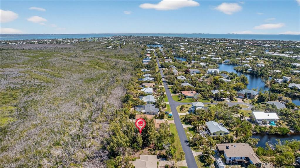 Aerial view of residential area featuring a large body of water