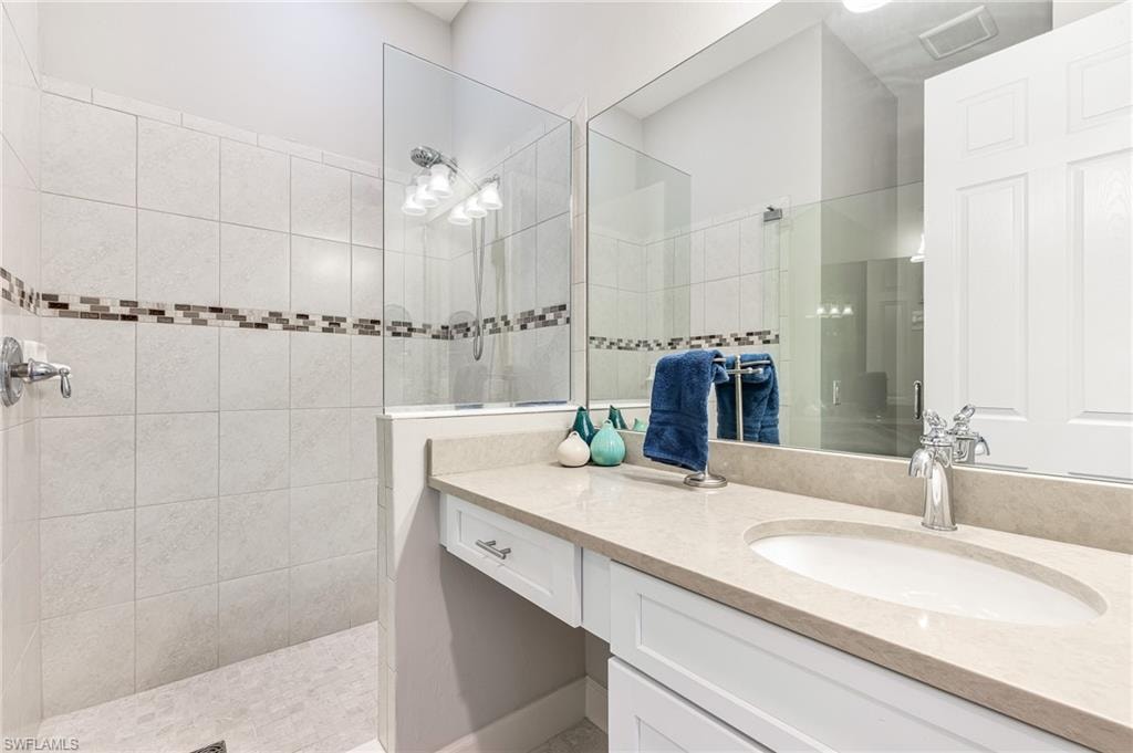 Bathroom featuring vanity and a walk in shower