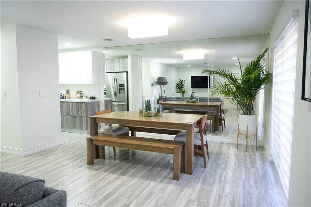 Dining room featuring light wood-style flooring and recessed lighting