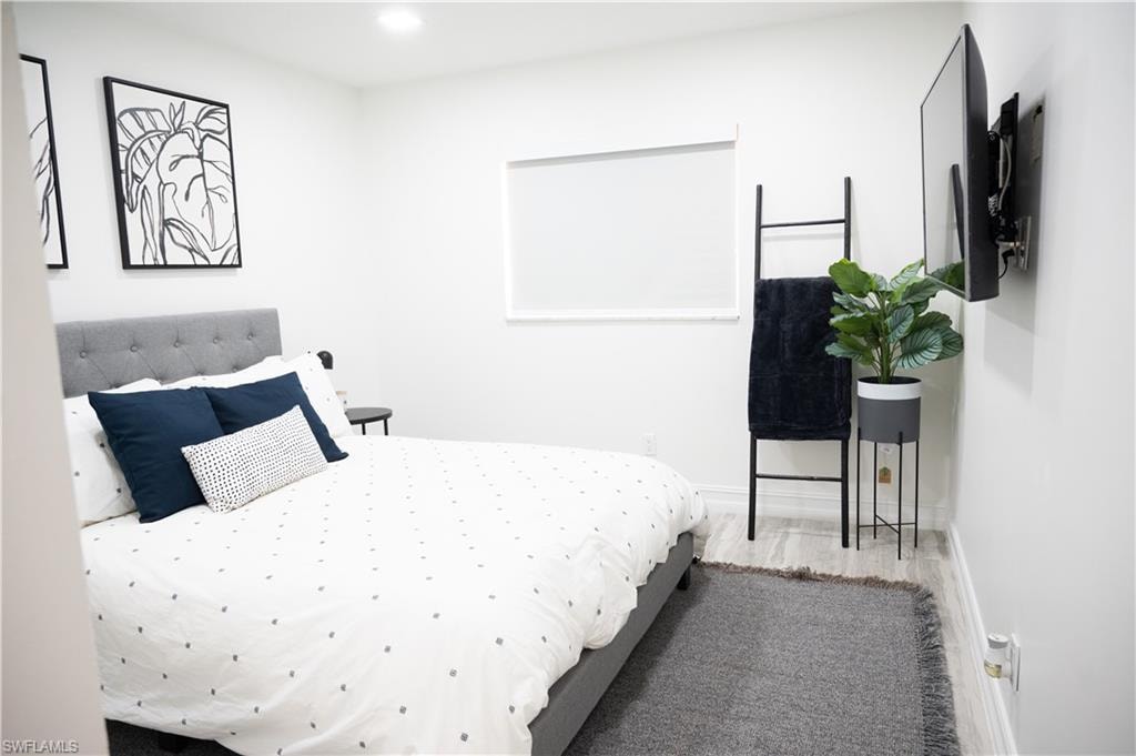 Bedroom featuring wood finished floors and recessed lighting
