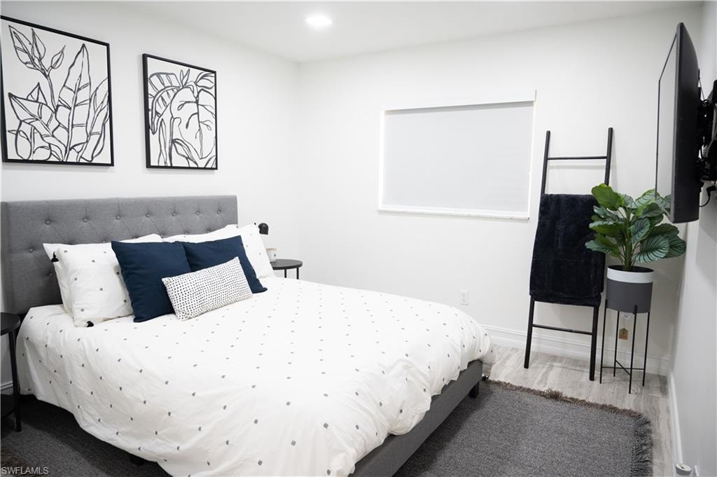 Bedroom featuring wood finished floors and recessed lighting