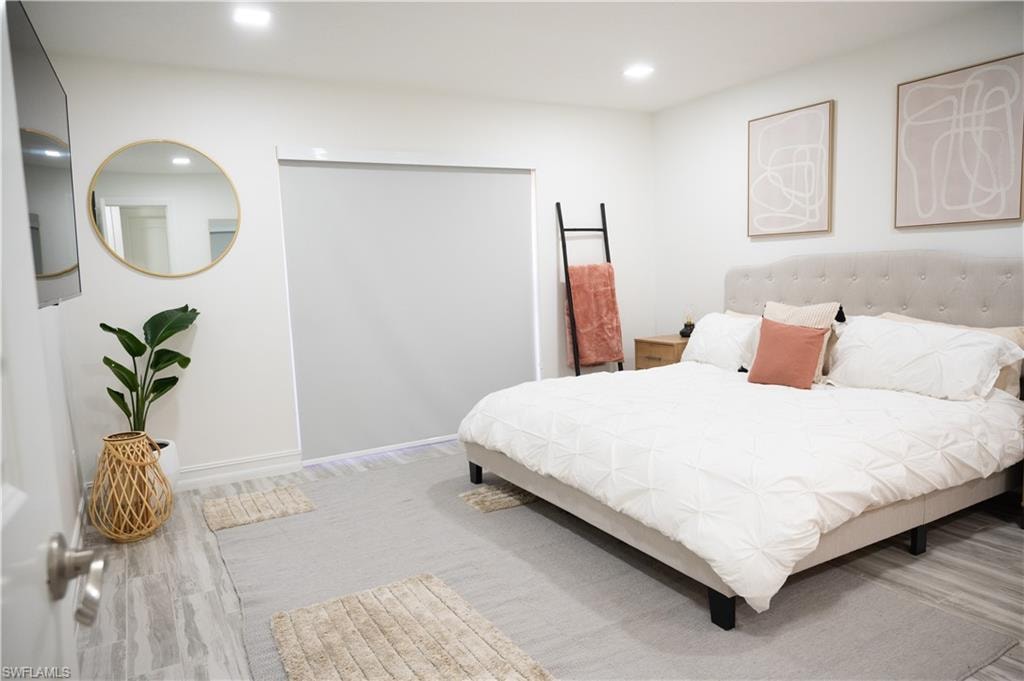 Bedroom with recessed lighting and light wood-style floors