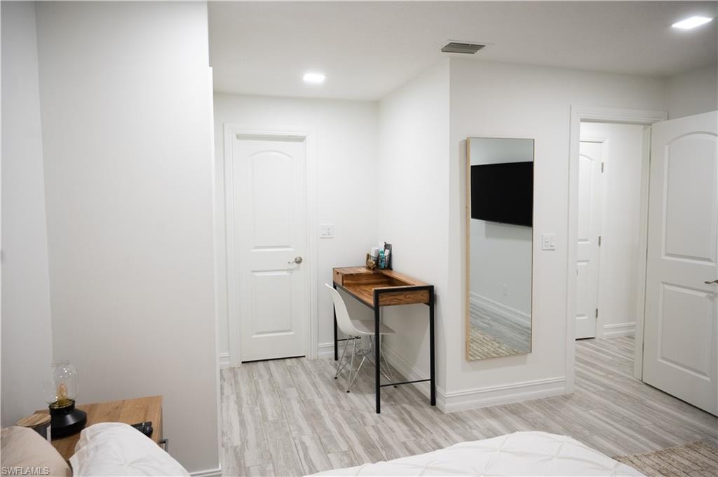 Bedroom with light wood-style flooring and recessed lighting