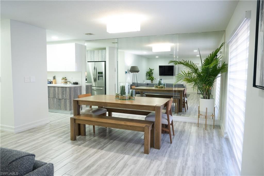Dining room featuring light wood-style flooring and baseboards