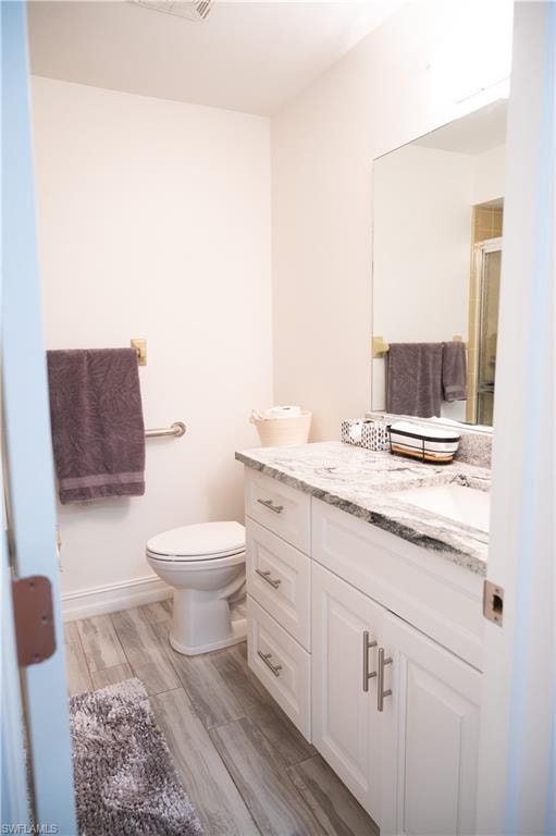 Bathroom featuring vanity and wood finish floors