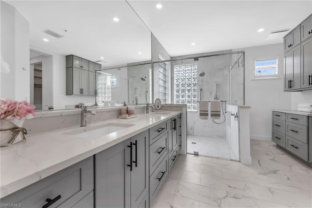 Updated primary bathroom, with an oversized walk in shower and dual sinks