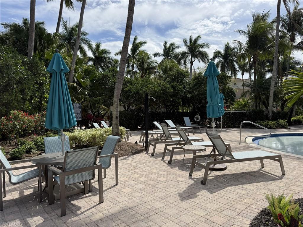 Pool patio with plenty of chairs and umbrellas