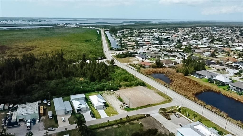 Aerial perspective of suburban area featuring a nearby body of water