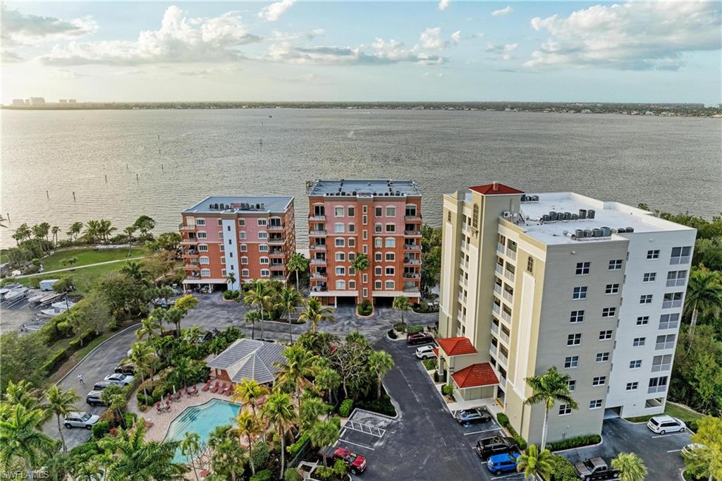 Drone / aerial view of apartment complex / building and a nearby body of water