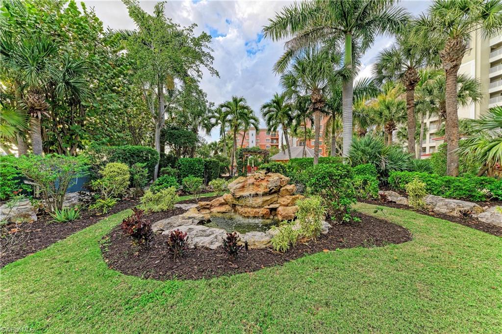 View of grassy yard with a garden pond