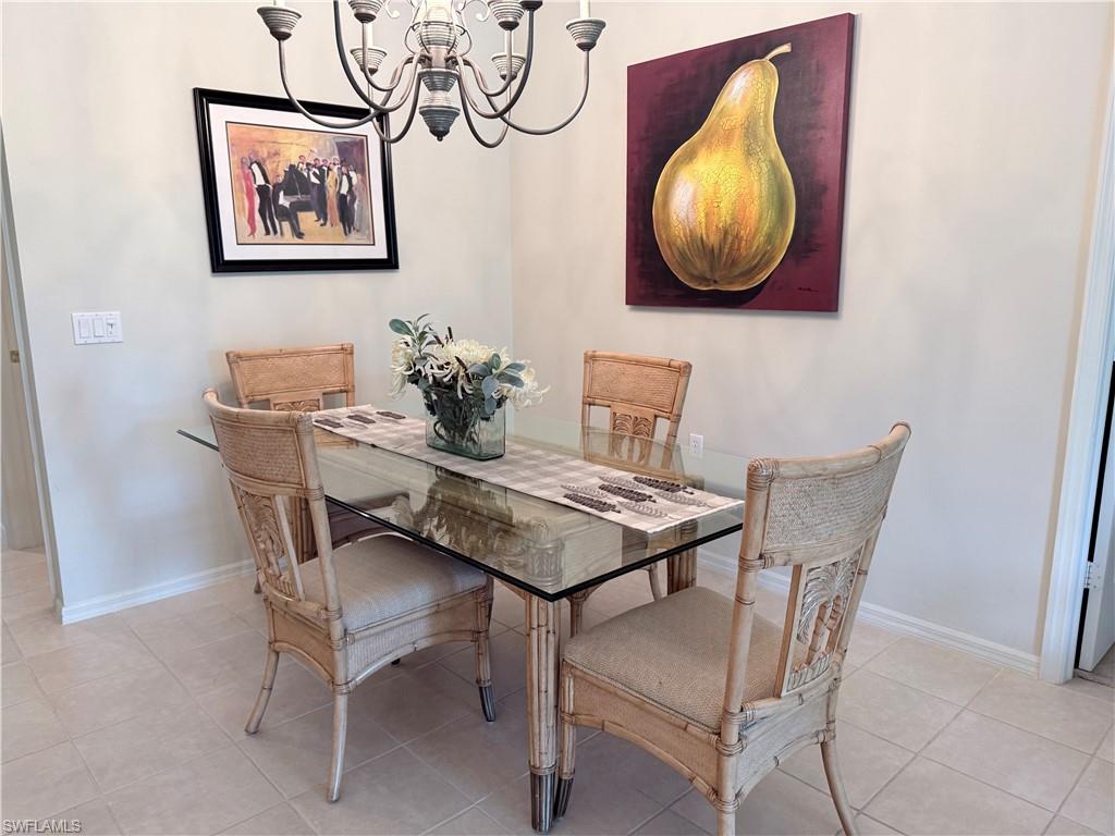 Dining room with hanging lights and baseboards