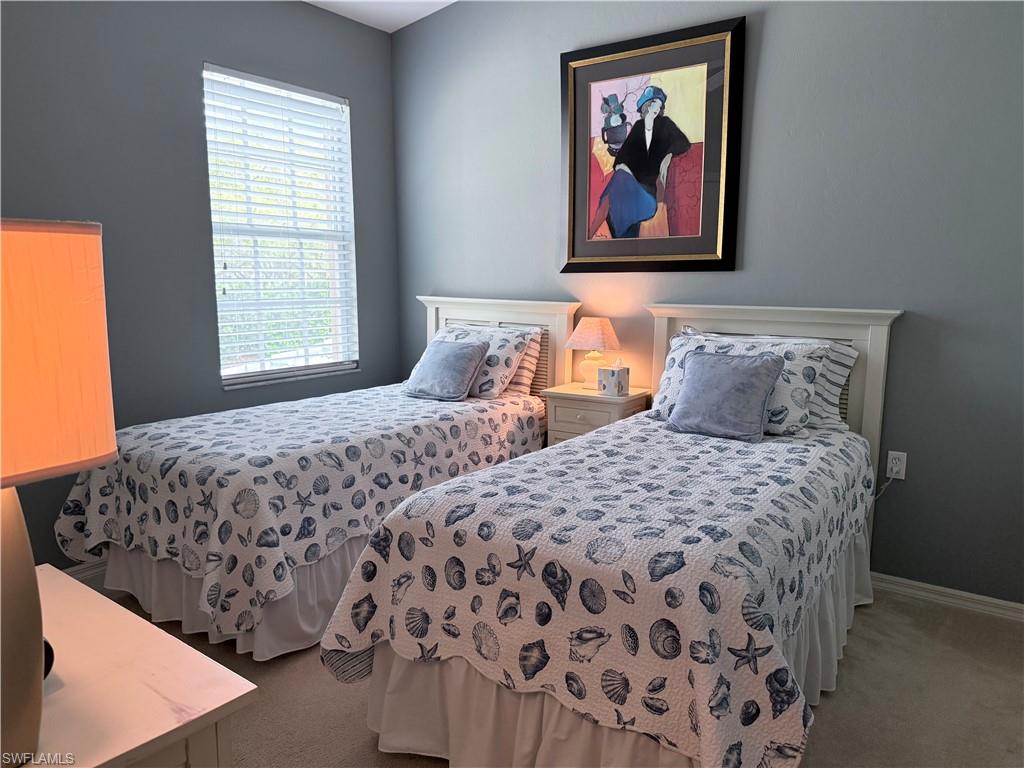 Carpeted bedroom featuring baseboards