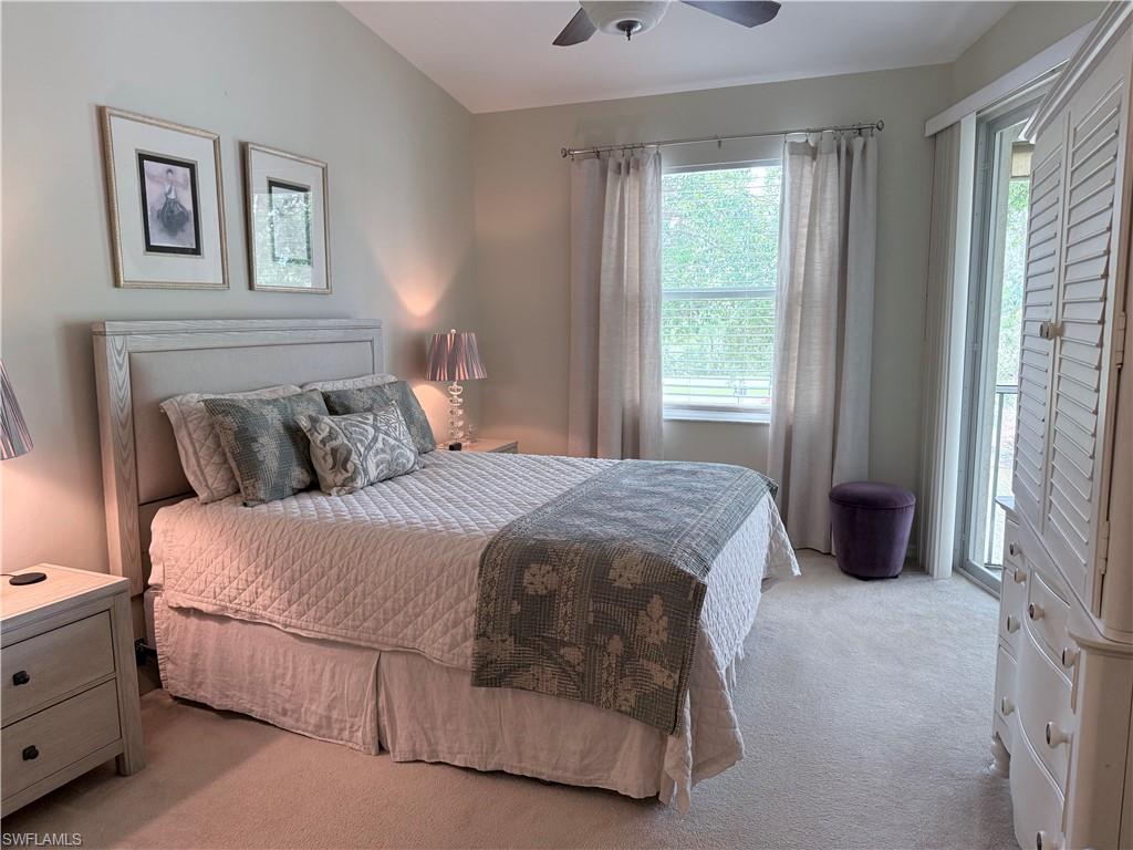 Bedroom featuring light colored carpet, access to outside, and a ceiling fan