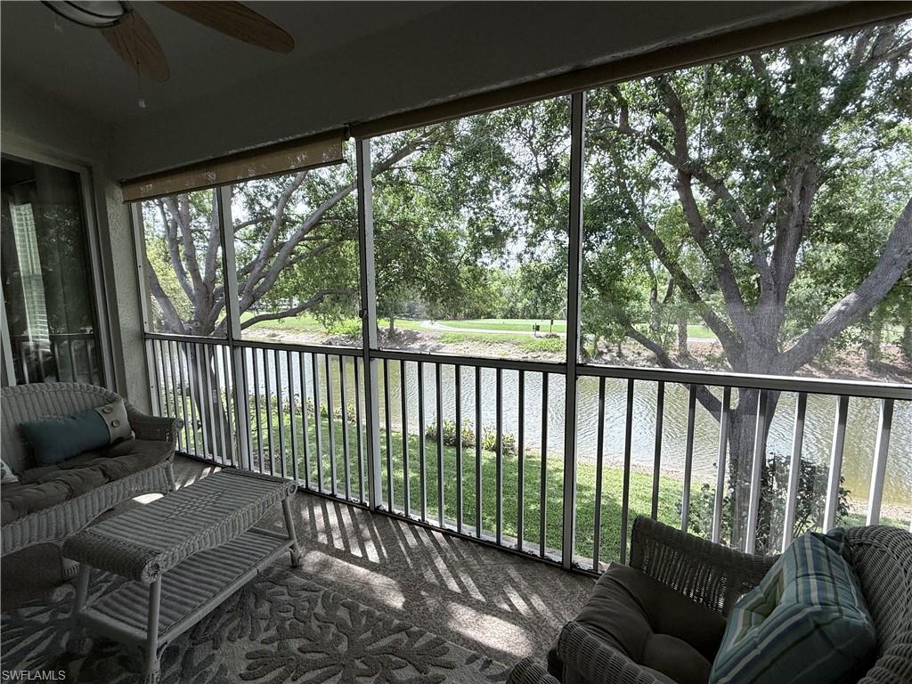 Lanai with a water view, and outdoor furniture
