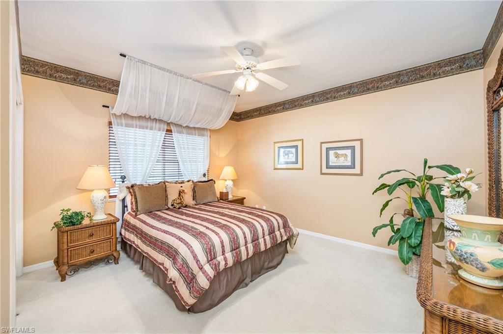 Bedroom featuring light carpet and a ceiling fan