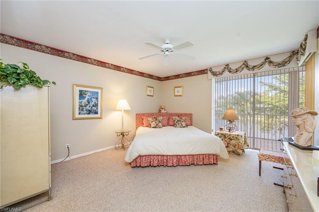Carpeted bedroom featuring a ceiling fan and access to exterior
