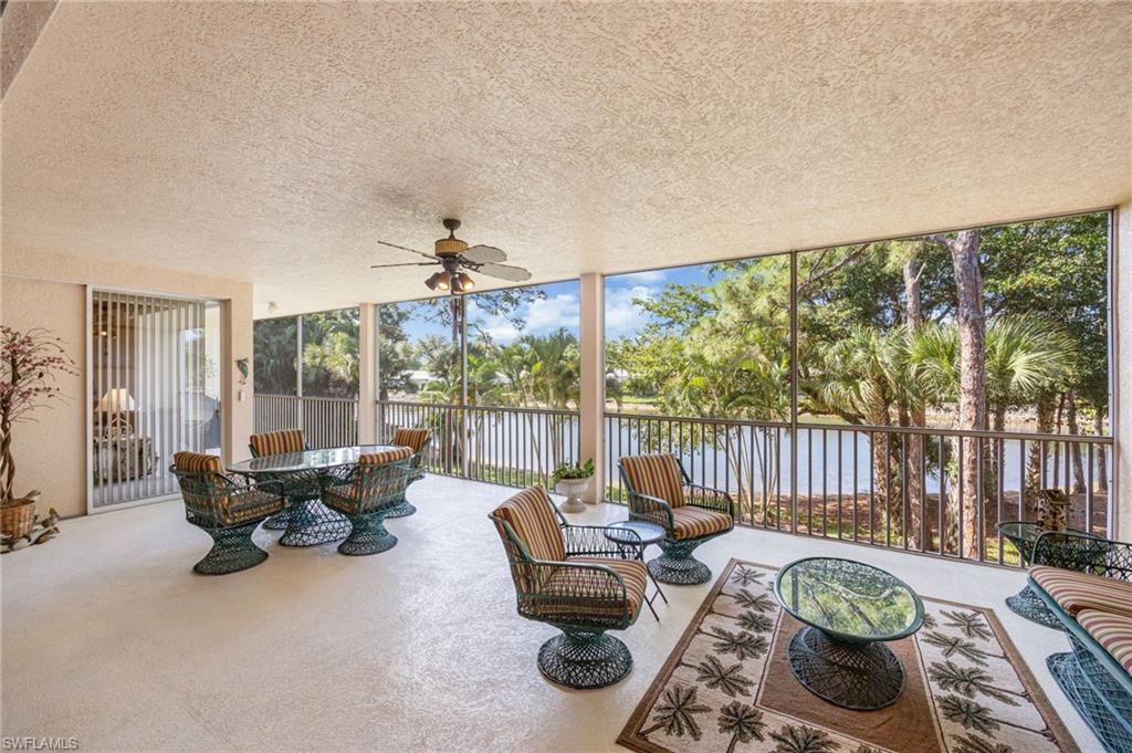 Sunroom with a ceiling fan, outdoor lounge area, and a water view