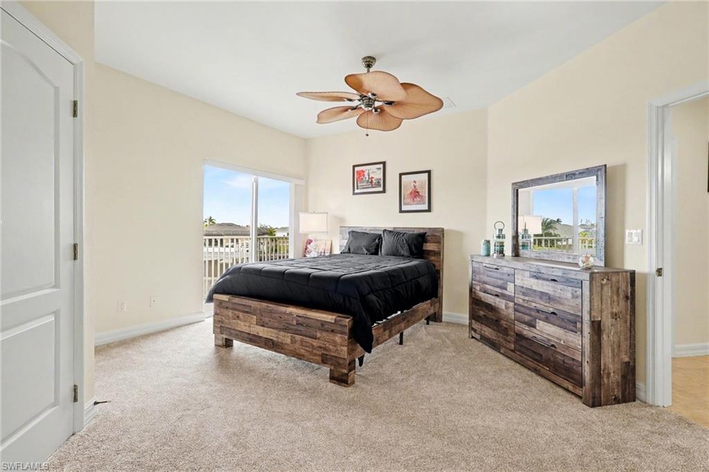 Bedroom with light colored carpet, access to outside, and a ceiling fan