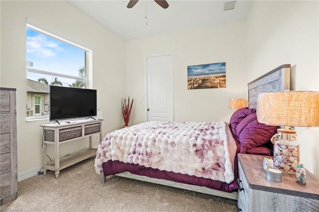 Bedroom featuring light carpet and a ceiling fan