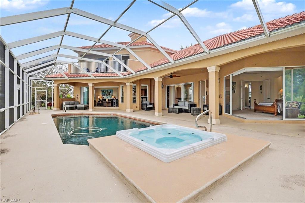 Integrated pool / spa with outdoor seating, a sunroom, glass enclosure, and a patio area