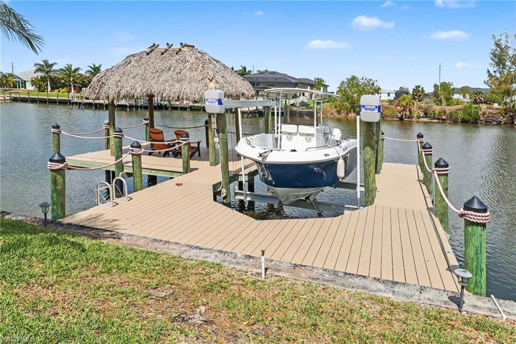 Dock area featuring boat lift and a water view