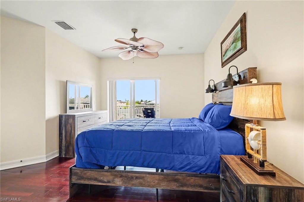 Bedroom featuring access to outside, ceiling fan, and dark wood-type flooring
