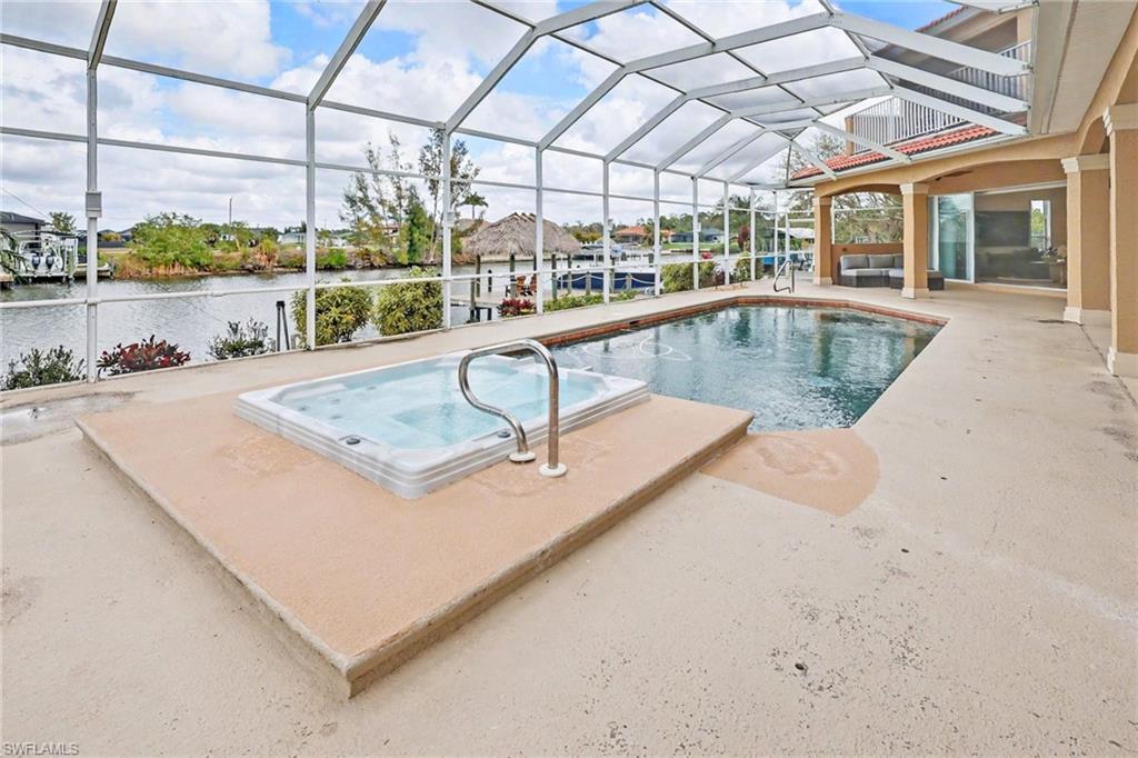 Swimming pool featuring a sunroom, a patio area, a lanai, and a balcony
