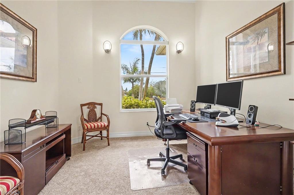 Office space featuring light carpet and baseboards
