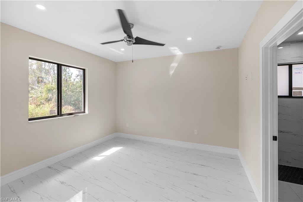 Spare room featuring light marble finish flooring, ceiling fan, and recessed lighting