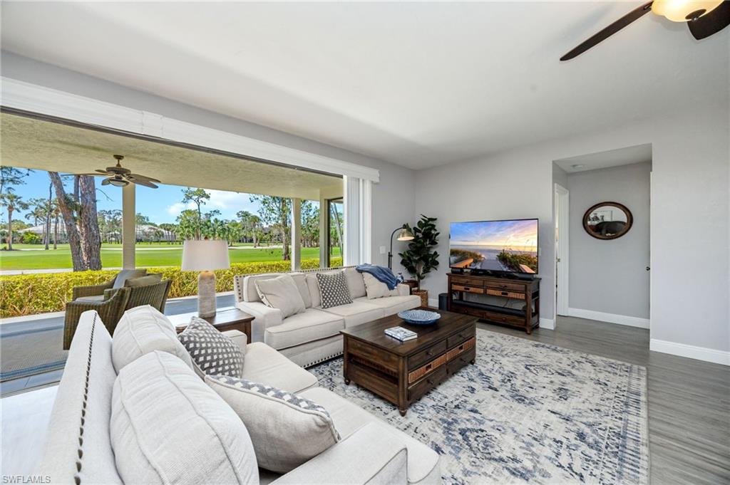 Living room with ceiling fan and wood finished floors