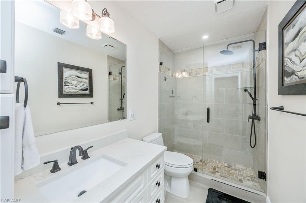 Bathroom featuring vanity and a shower stall