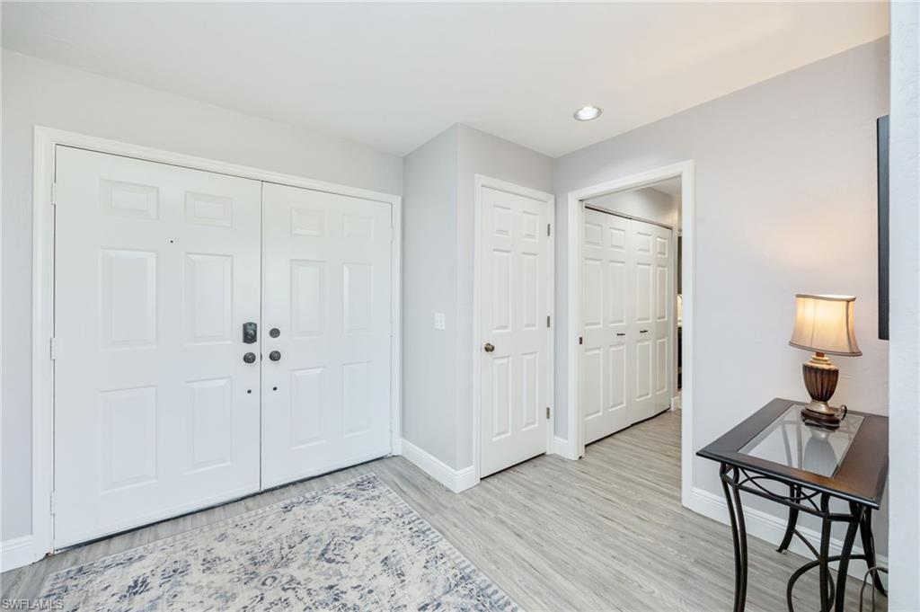 Entryway featuring baseboards and light wood-type flooring