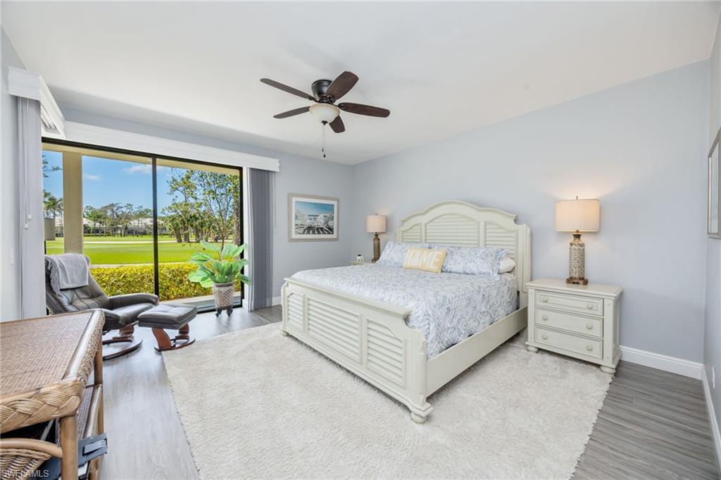 Bedroom featuring access to outside, a ceiling fan, light wood-style floors, and view of golf course