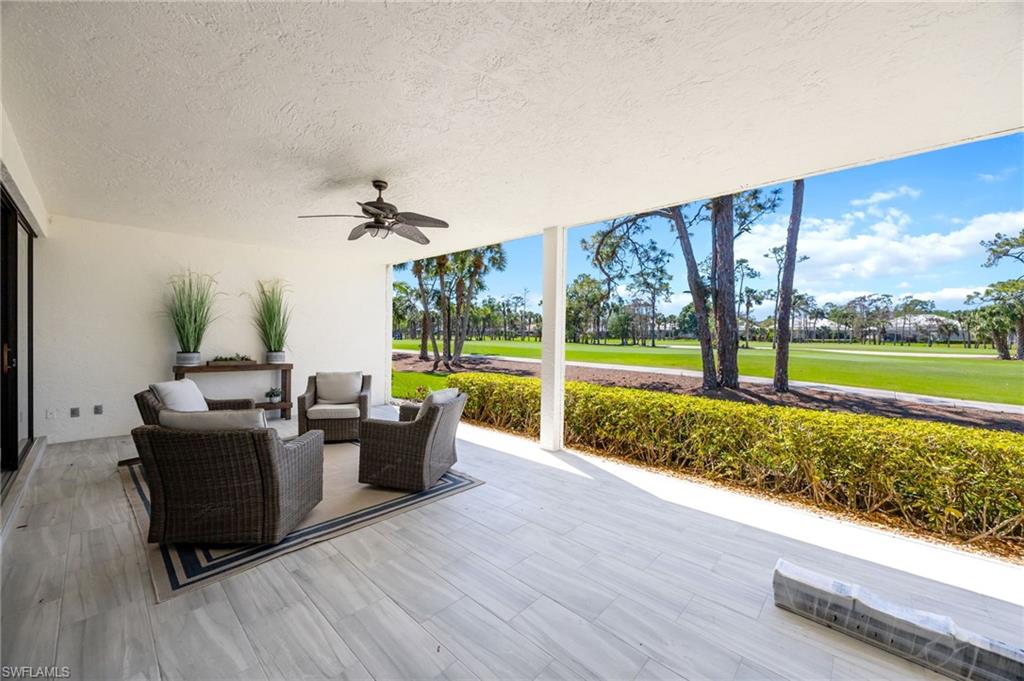 View of patio / terrace with a ceiling fan, outdoor furniture, and golf course view